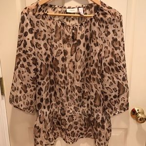 Sheer leopard print blouse with gold accents.